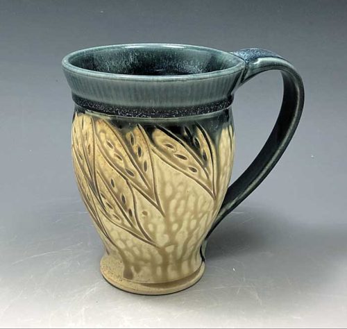 hand carved stoneware mug with leaf pattern by Ira Burhans