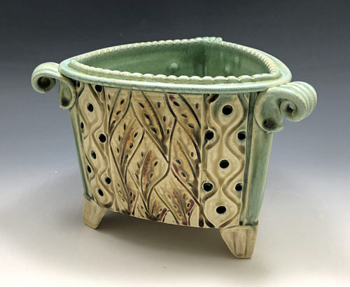 Triangle shaped stoneware pot with curly handles by Ira Burhans