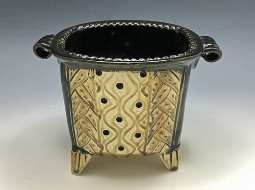footed rectangle pot in black and tan by Ira Burhans